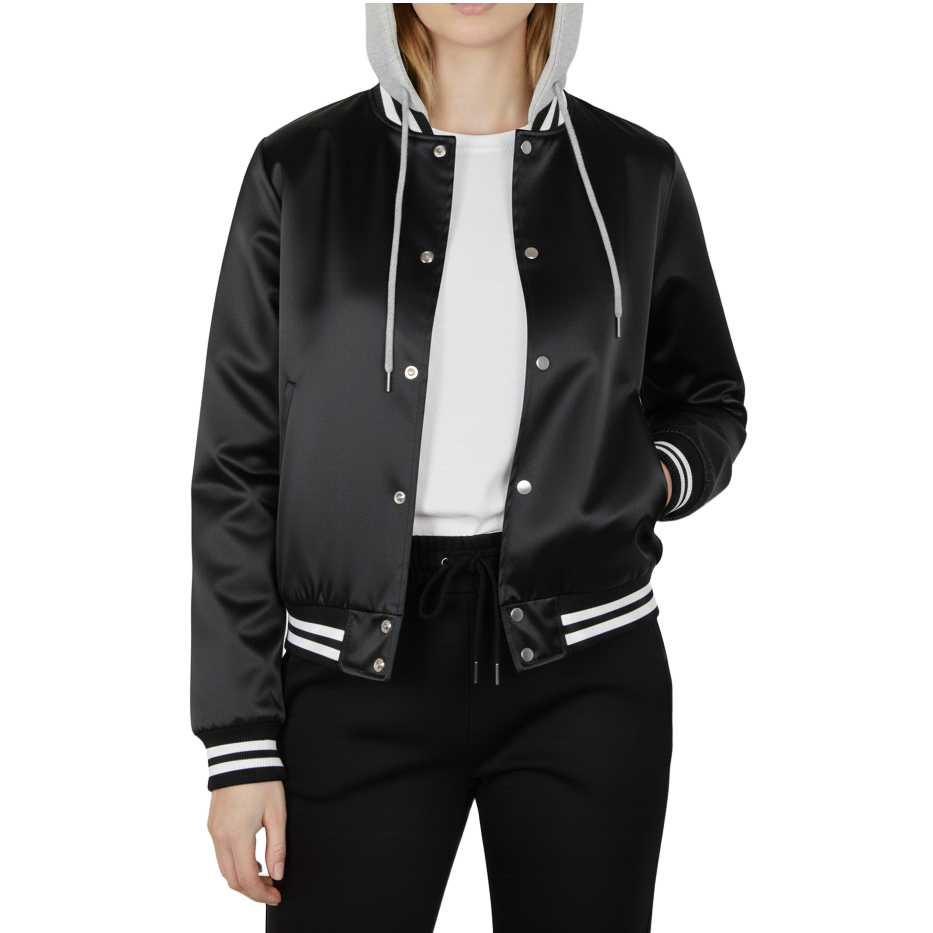 Person wearing a black varsity jacket with white accents on a white background